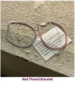 Detail of S925 silver double-layered red and black braided bracelets with zircon charms