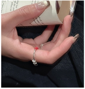 Detail of S925 sterling silver ring featuring red rope weaving and adjustable metal beads
