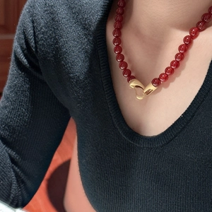 S925 silver red beaded necklace with vintage gold buckle on model with black knitwear