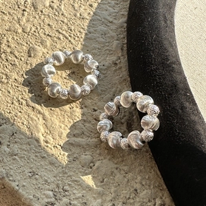 S925 sterling silver beaded ring featuring textured beads on a stone surface