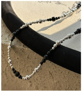 Detail of S925 silver and black onyx beaded necklace with gradient sized spheres