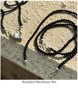 Detail of S925 silver necklace with black agate beads and vintage heart pendant clasp