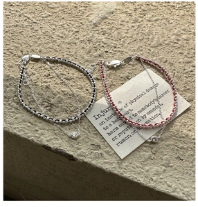 Detail of S925 sterling silver stamp on double-layer woven red and black zircon bracelets