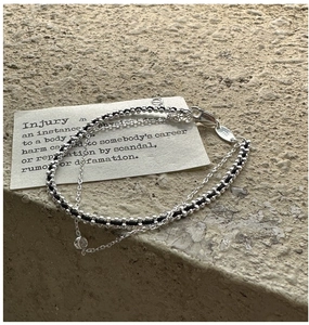 Detail of S925 silver double-layer bracelet with braided cord and zircon stone