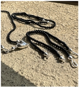 Detail view of the black onyx beaded necklace with a molten heart silver pendant