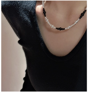 Detailed view of S925 silver and black onyx beads necklace on a model's neck