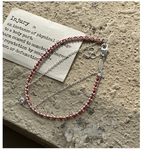 Detail of S925 silver red rope bracelet with double layer weave and zircon stone