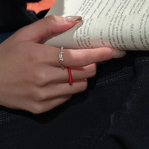 S925 sterling silver T-design ring and red braided rope ring set on a magazine background