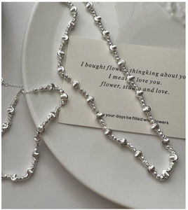 Close-up of 925 silver cat eye necklace with textured beads and lobster clasp detail