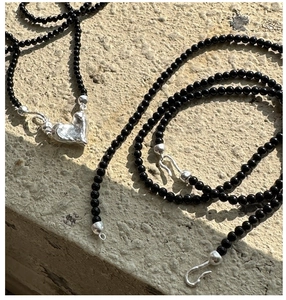 Detail of S925 silver clasp and black onyx beads with irregular heart pendant