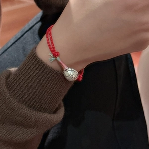 Handcrafted red string bracelet with S925 silver tortoise shell charm on model wrist
