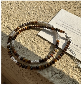 Detail of faceted brown tiger eye beads with silver spacers and adjustable clasp
