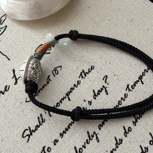Handcrafted black rope bracelet with vintage silver tortoise shell bead on artistic base