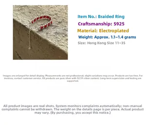 Macro detail of S925 sterling silver chain woven with red thread for New Year ring