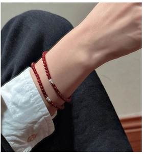 Close-up of double-layer red agate beaded bracelet with silver accents on a female wrist