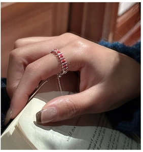 Close-up of S925 sterling silver ring with red gems and adjustable chain detail