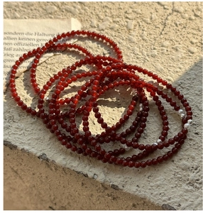 Close-up of 925 silver red agate beaded bracelets with pearls on stone background