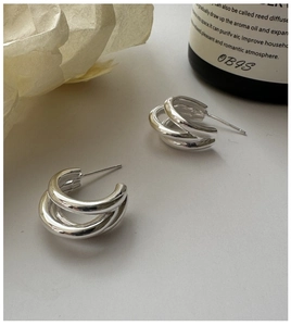 Close-up of S925 sterling silver three-layer hoop earrings with a sleek mirror finish