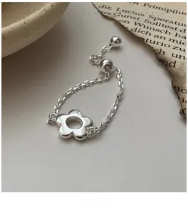 Vue détaillée d'une bague fleur en argent S925 avec une chaîne coulissante réglable