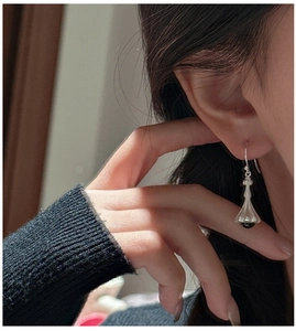 Detailed close-up of S925 sterling silver lily of the valley earrings with black agate