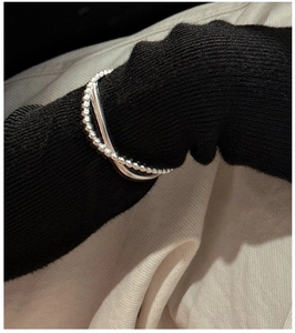 Close-up of minimalist S925 sterling silver double-layer bracelet with beaded and wavy chains
