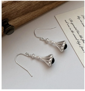 Detailed close-up of S925 silver retro flower earrings with round black agate beads