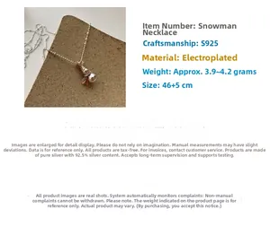 Macro shot of S925 sterling silver snowman pendant necklace with polished bead chain