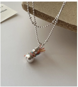 Detail of 925 silver snowman pendant necklace with colorful hand-woven thread accents