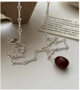 Macro shot of S925 sterling silver chain with red agate pendant and S925 hallmark