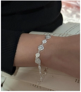 Close-up of S925 silver bracelet featuring textured lava style charms and adjustable chain