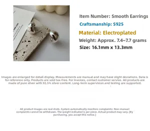 Macro detail of S925 sterling silver curved hoop earrings on stone textured background