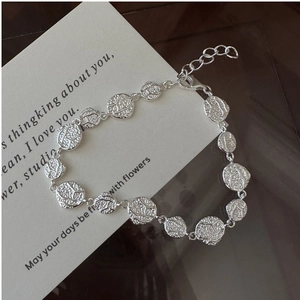 Detailed close-up of textured S925 silver bracelet links with lobster clasp and chain