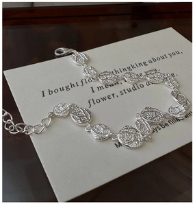 Close-up of S925 sterling silver textured leaf bracelet with lobster clasp on card