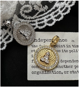 Macro shot of S925 sterling silver coin pendants in gold and silver finish with pavé stones