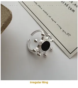 Macro detail of S925 sterling silver irregular ring with round black agate stone inlay