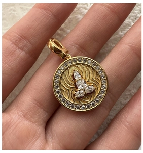 Detailed close-up of a S925 silver gold-plated pendant with sparkling zircons