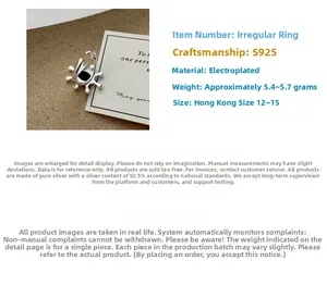 Detailed macro view of S925 sterling silver ring with irregular sunburst texture and black stone
