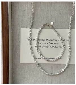 Macro view of S925 sterling silver irregular beads necklace and bracelet set with heart tag