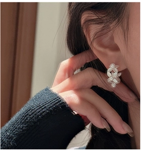 Close-up of S925 sterling silver leaf earring with shell pearls on model ear