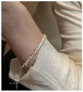 Close-up of S925 sterling silver irregular nugget bracelet with adjustable chain on wrist