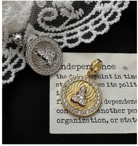 Macro view of S925 silver coin pendants with pear-shaped cubic zirconia and wave pattern