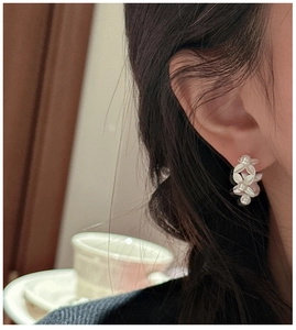 Close-up of S925 silver leaf pearl cluster earrings on model for an elegant retro style