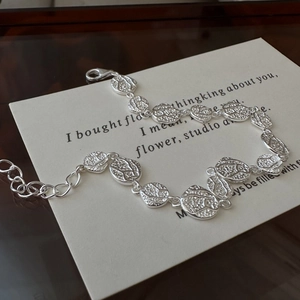 S925 sterling silver textured circular link bracelet on artistic stationery background