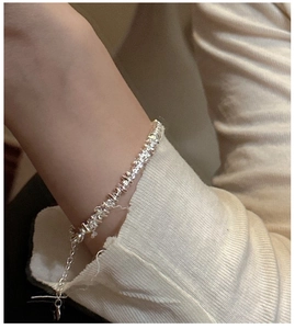 Macro shot of S925 sterling silver minimalist beaded bracelet on a wrist with extension chain