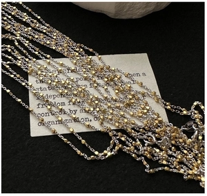 Close-up of S925 sterling silver chain featuring two-tone gold and silver beaded texture