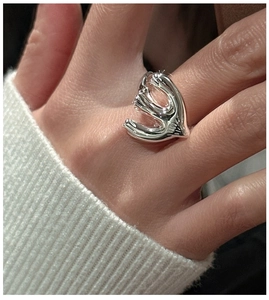 Macro detail of S925 silver ring featuring an artistic abstract wing sculpture design