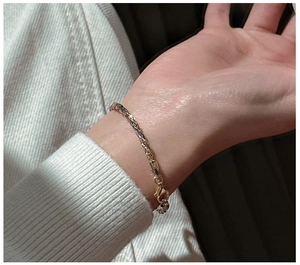 Detailed view of Italian S925 sterling silver triple-layer chain with braided gold texture