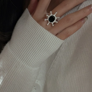 S925 sterling silver sunburst ring with black agate on model wearing white sweater