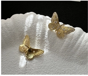 Macro shot of S925 sterling silver butterfly earrings with pavé zircon stones and hallmark