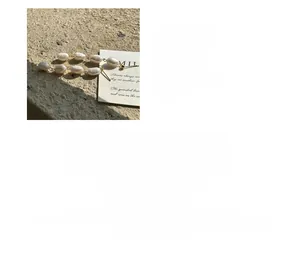 Detailed view of S925 silver earrings with four natural Baroque pearls and organic texture
